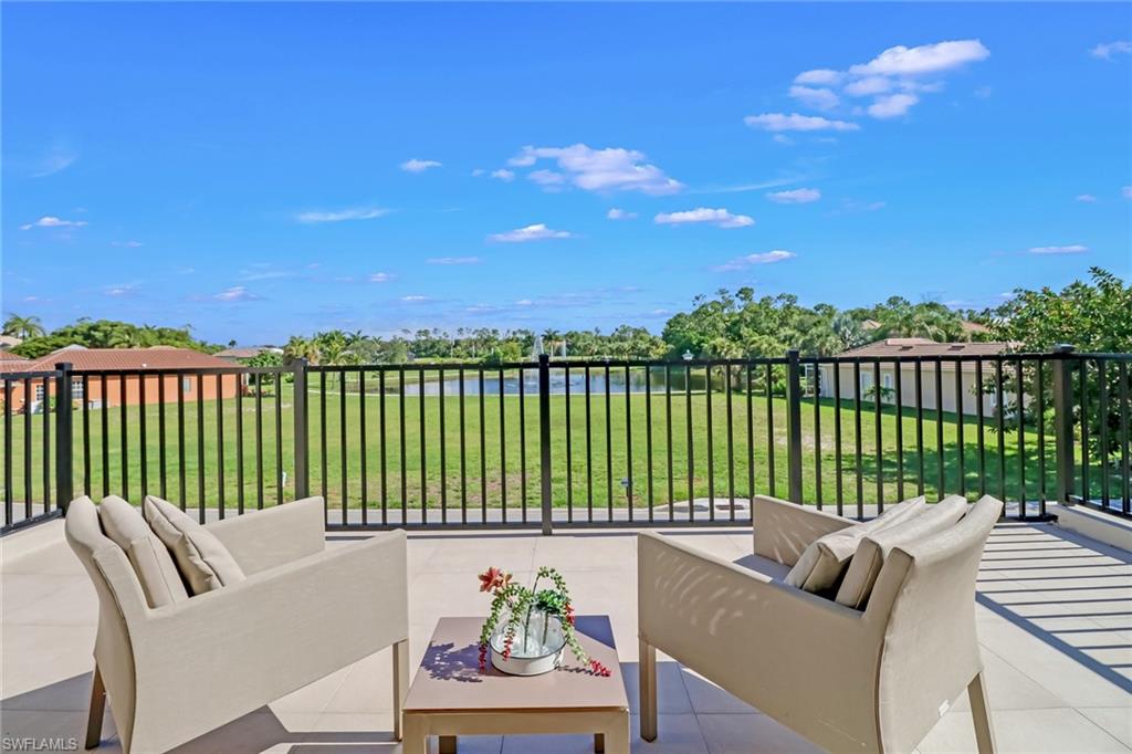 2875 Coco Lakes Drive Naples, FL 34105 - Photo 17 of 27 a roof deck with couches and city view