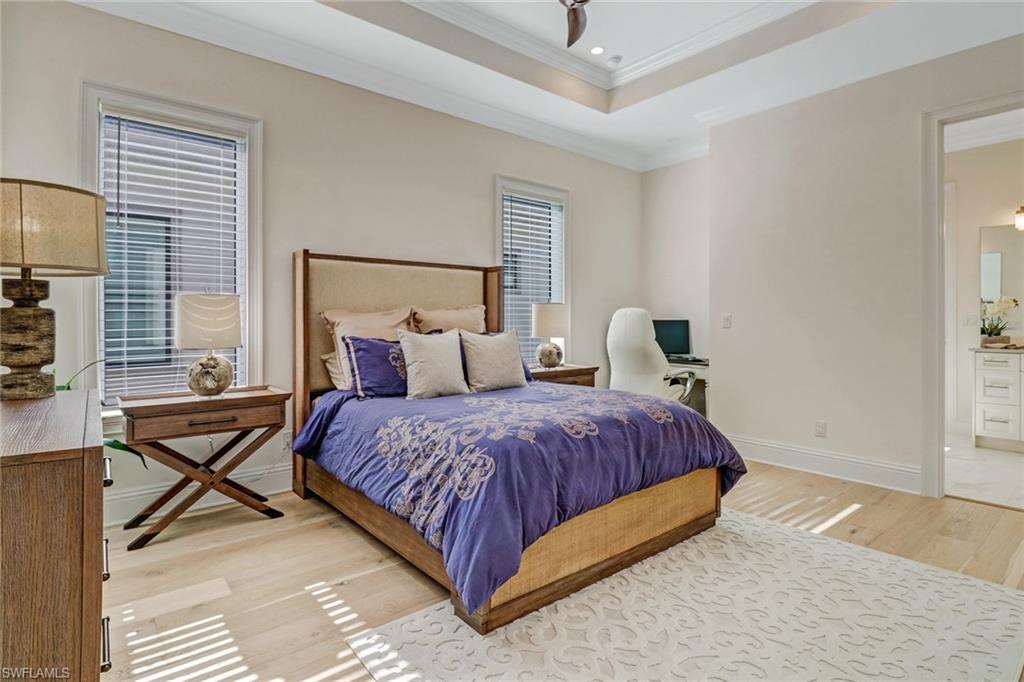 2875 Coco Lakes Drive Naples, FL 34105 - Photo 18 of 27 a spacious bedroom with a bed and chair