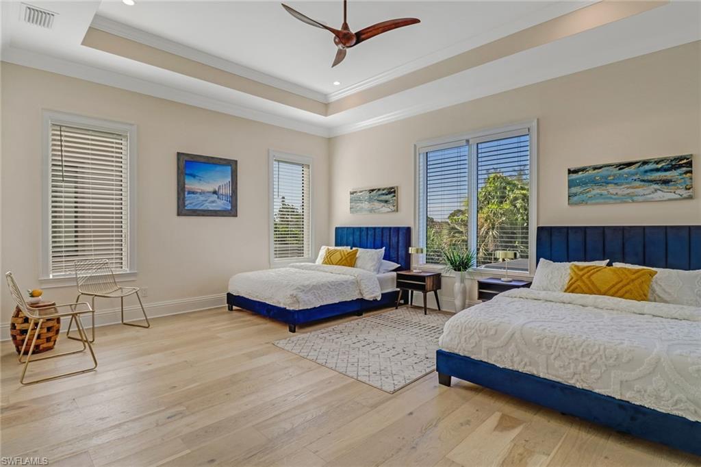 2875 Coco Lakes Drive Naples, FL 34105 - Photo 19 of 27 a bedroom with two beds and a large window