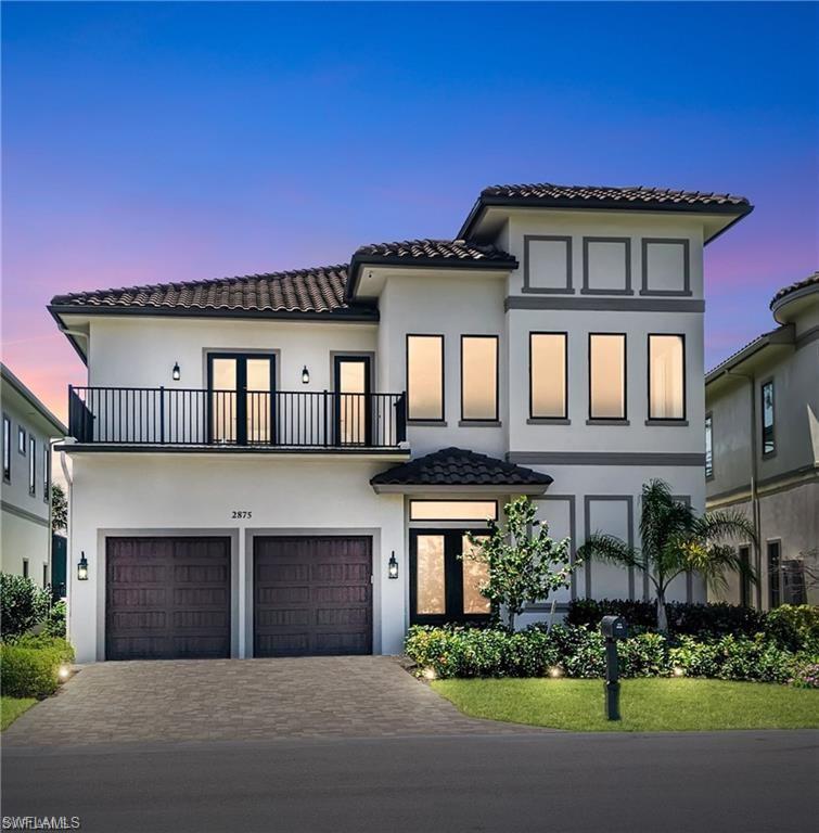 2875 Coco Lakes Drive Naples, FL 34105 - Photo 2 of 27 a front view of a house with a garden