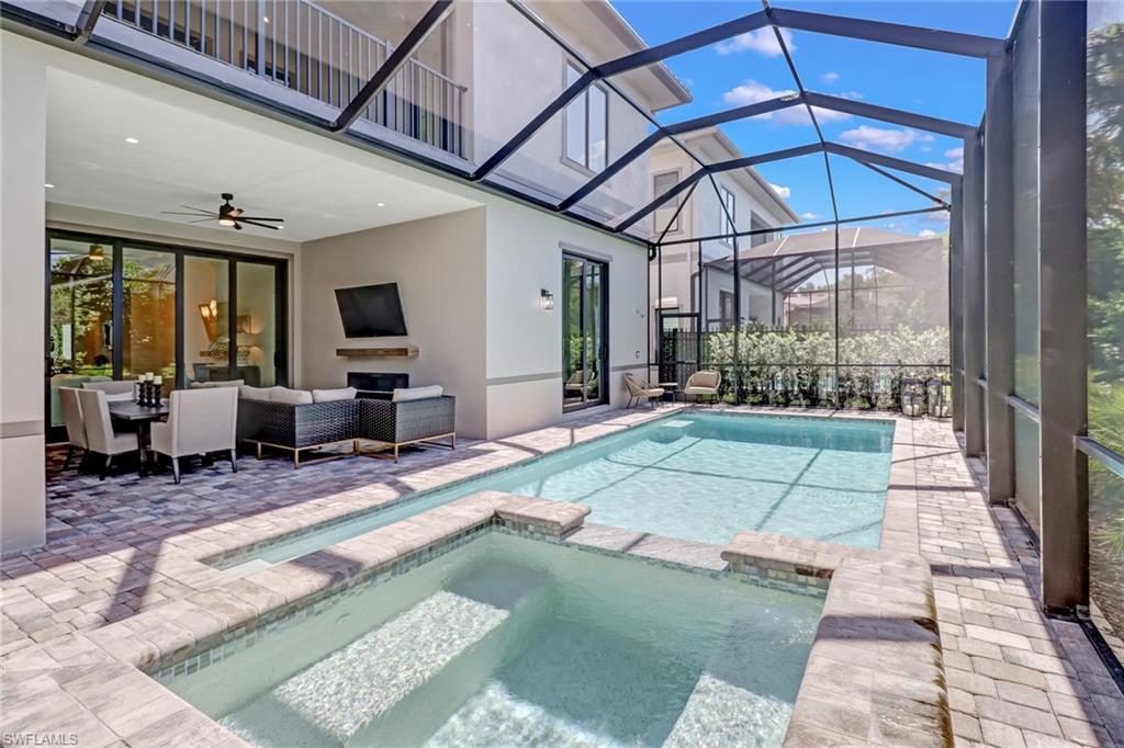 2875 Coco Lakes Drive Naples, FL 34105 - Photo 25 of 27 a view of a porch with furniture and a yard
