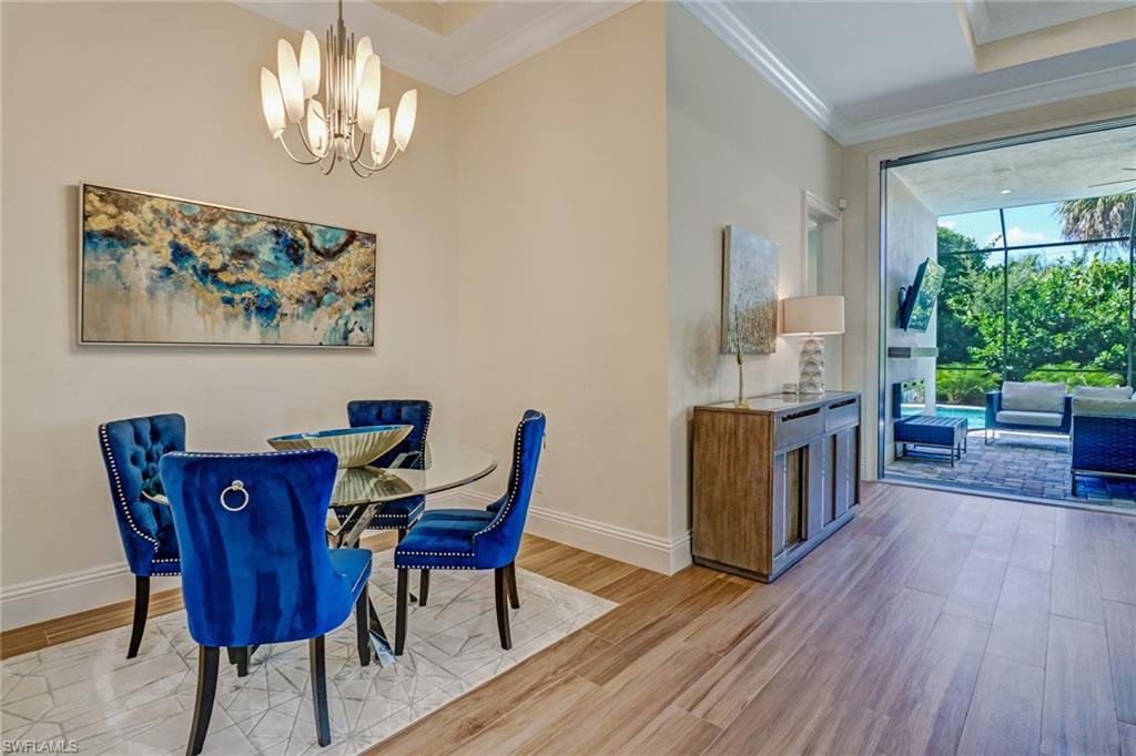 2875 Coco Lakes Drive Naples, FL 34105 - Photo 8 of 27 a view of a dining room with furniture window and wooden floor