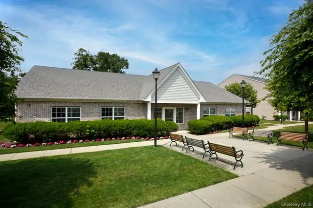 a front view of a house with a yard table and chairs