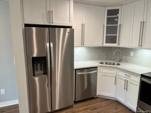 a kitchen with stainless steel appliances a refrigerator sink and cabinets