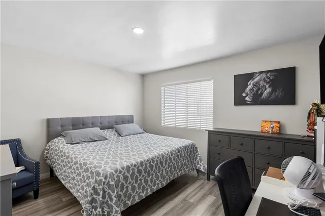 a bedroom with a bed and wooden floor