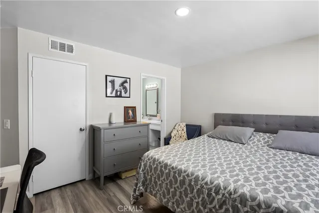 a bedroom with a bed and cabinet