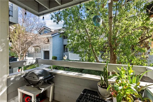 a view of a chairs and table in the back yard of a house