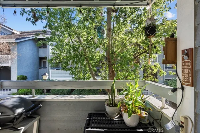 a view of a patio with furniture and a garden