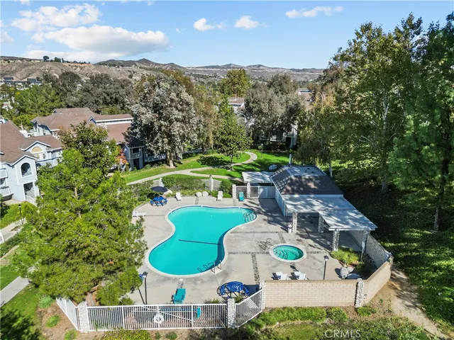 a aerial view of a house with a swimming pool and outdoor space