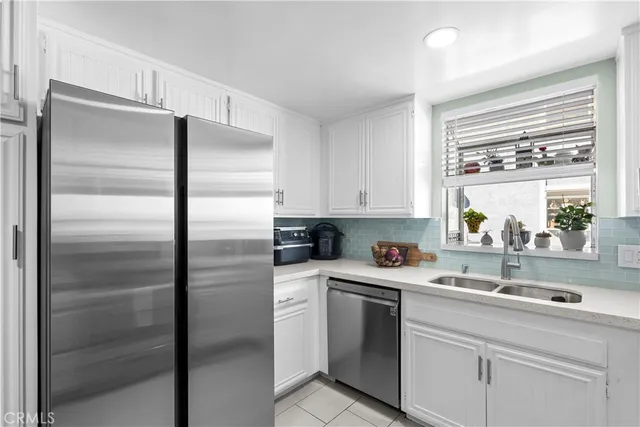 a kitchen with a sink and a refrigerator