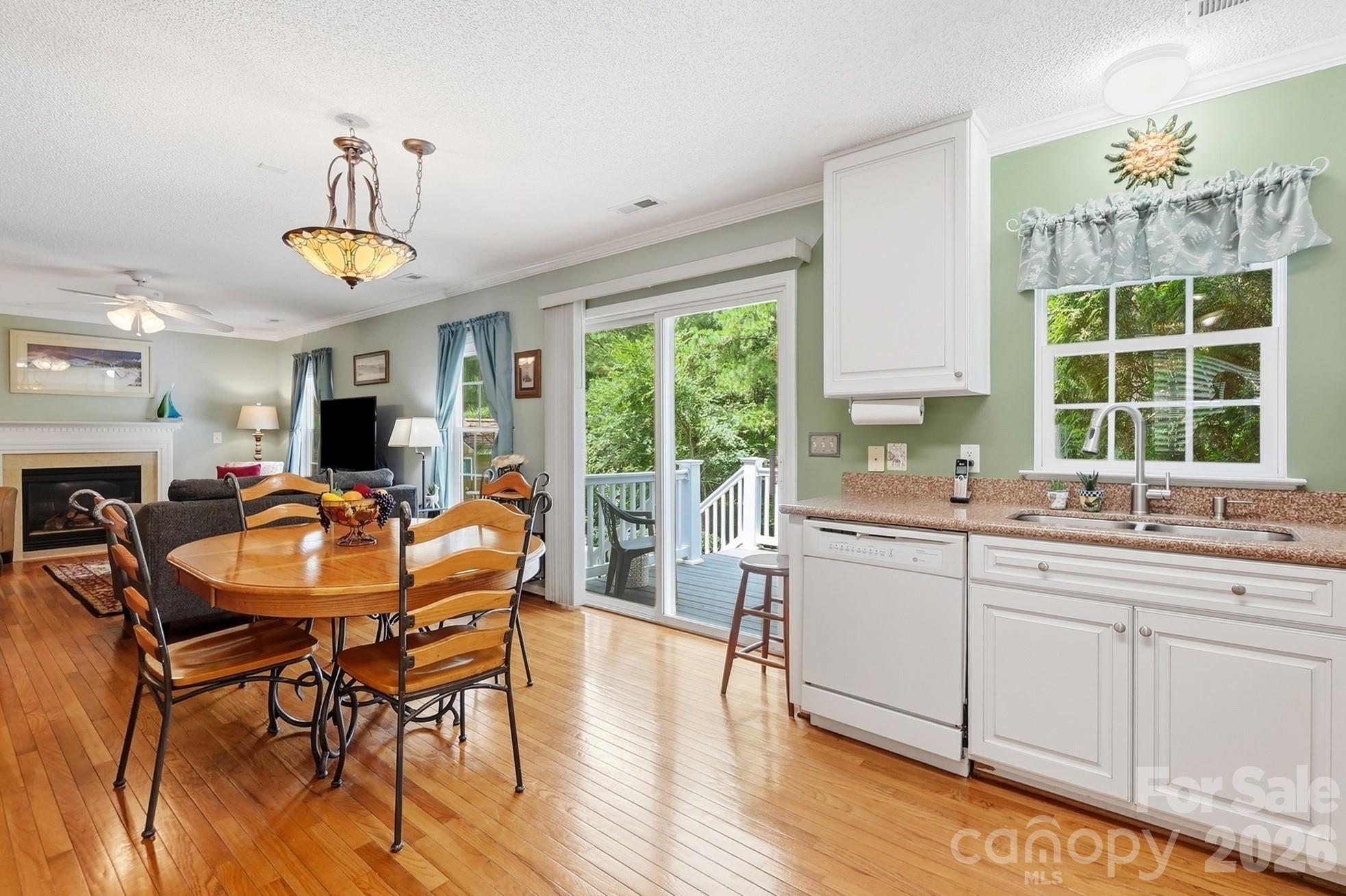 442 Sugar Maple Drive Tega Cay, SC 29708 - Photo 12 of 48 a kitchen with a table chairs sink and cabinets