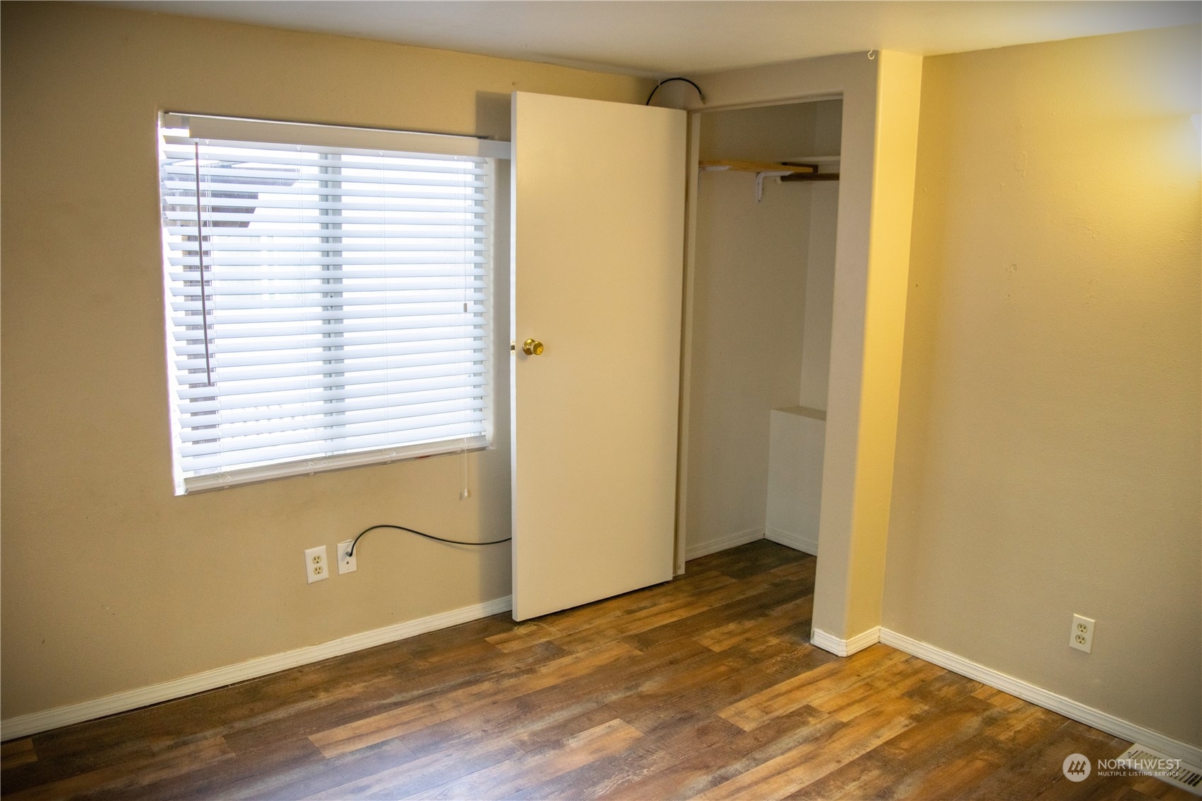 7701 Hardeson Road, Unit 2 Everett, WA 98203 - Photo 12 of 25 a view of an empty room with wooden floor and a window
