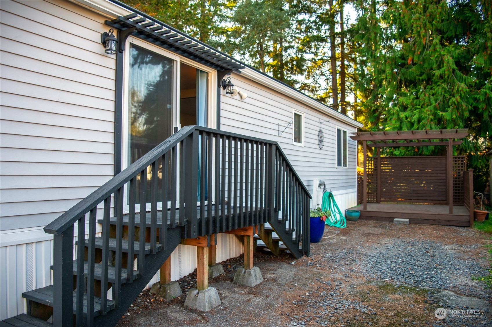 7701 Hardeson Road, Unit 2 Everett, WA 98203 - Photo 22 of 25 a view of wooden house with a yard and deck