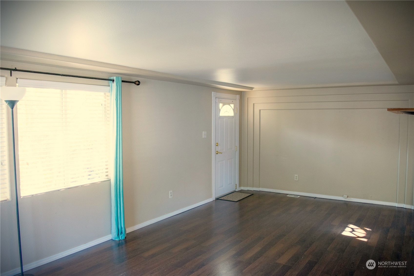 7701 Hardeson Road, Unit 2 Everett, WA 98203 - Photo 4 of 25 a view of an empty room with wooden floor and a window