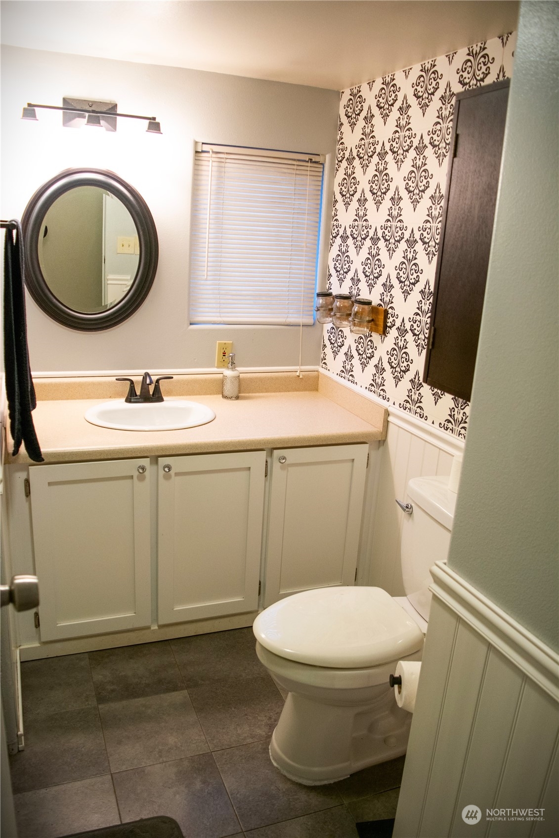 7701 Hardeson Road, Unit 2 Everett, WA 98203 - Photo 10 of 25 a bathroom with a sink a toilet and a mirror