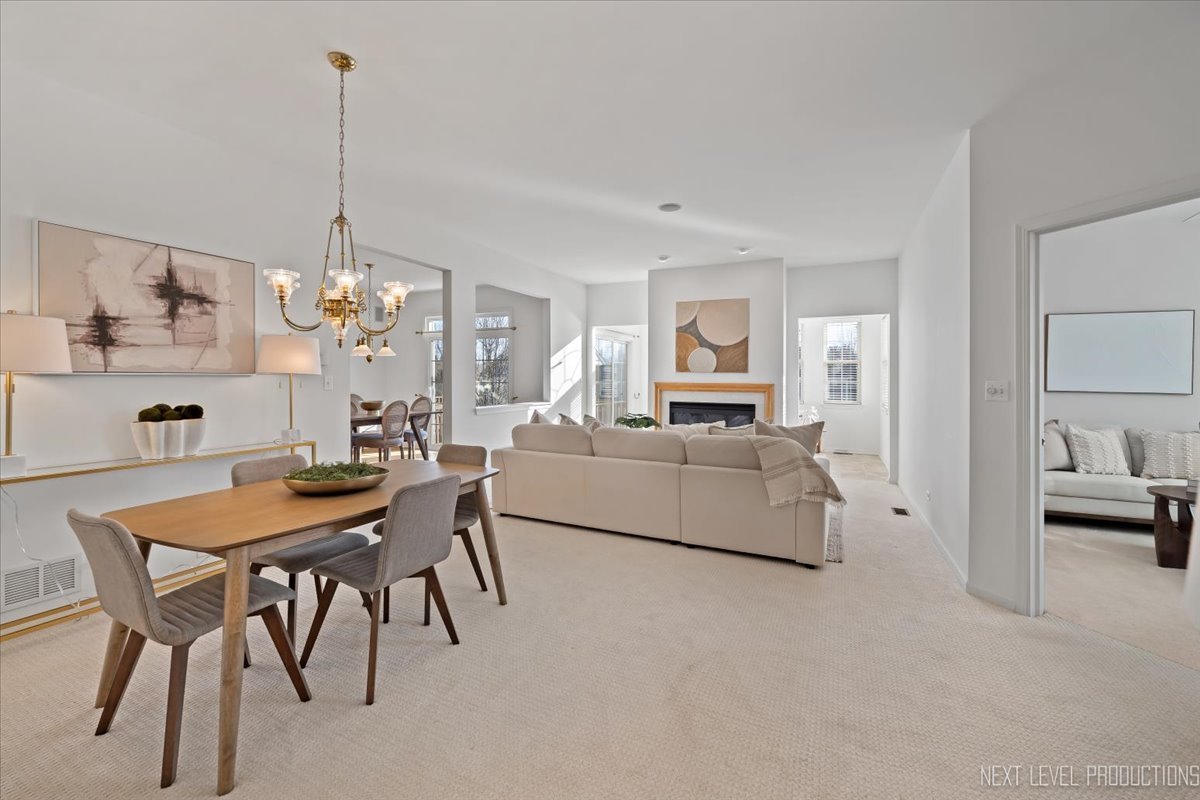 810 Cambridge Drive Batavia, IL 60510 - Photo 13 of 34 a living room with furniture and a chandelier