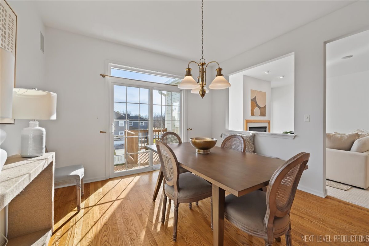 810 Cambridge Drive Batavia, IL 60510 - Photo 16 of 34 a view of a dining room with furniture window and wooden floor