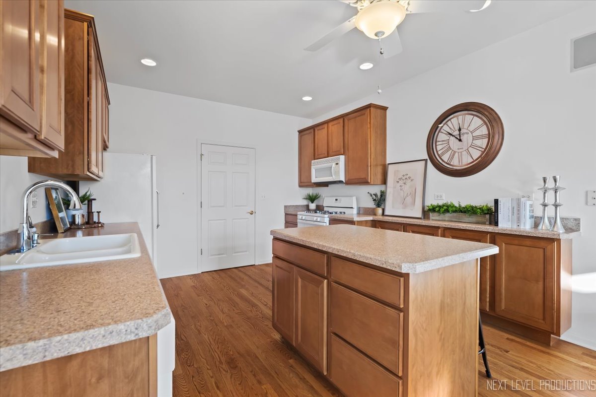 810 Cambridge Drive Batavia, IL 60510 - Photo 18 of 34 a kitchen with a sink a clock and cabinets