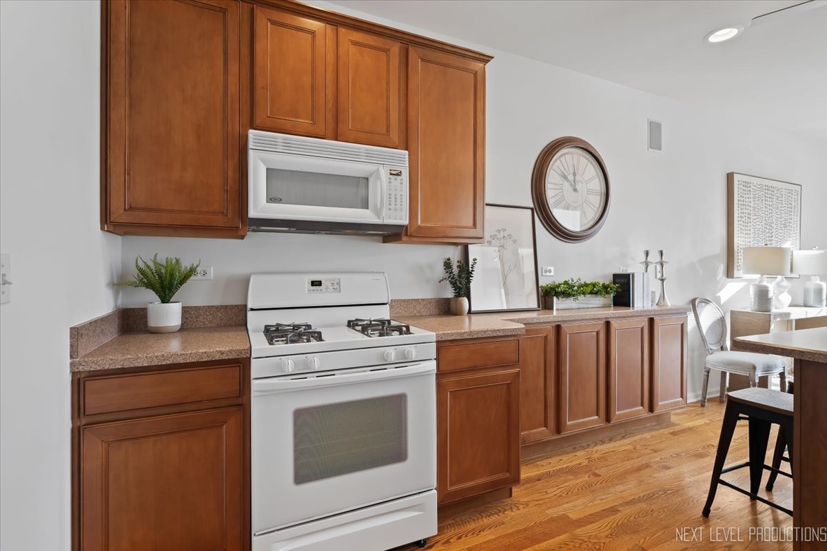 810 Cambridge Drive Batavia, IL 60510 - Photo 19 of 34 a kitchen with a stove cabinets and wooden floor