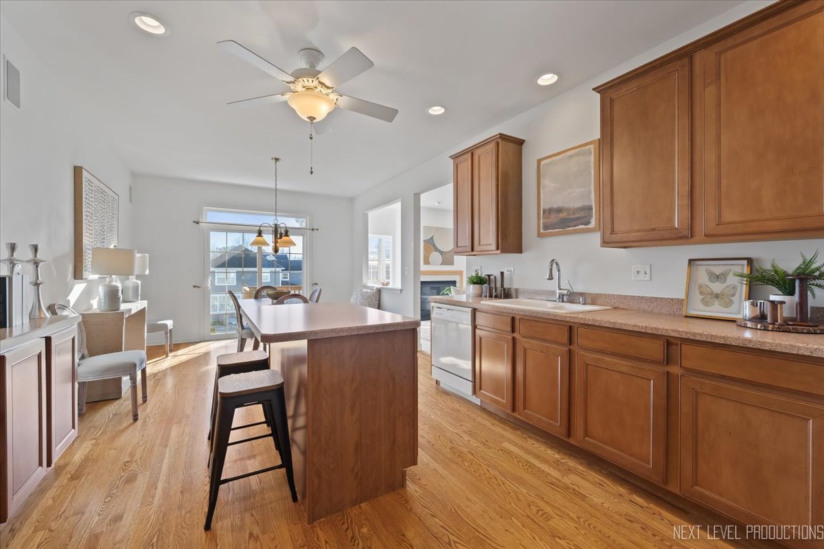 810 Cambridge Drive Batavia, IL 60510 - Photo 20 of 34 a kitchen with a dining table chairs and white cabinets