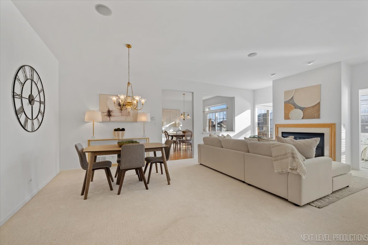 810 Cambridge Drive Batavia, IL 60510 - Photo 4 of 34 a living room with furniture a clock and a window