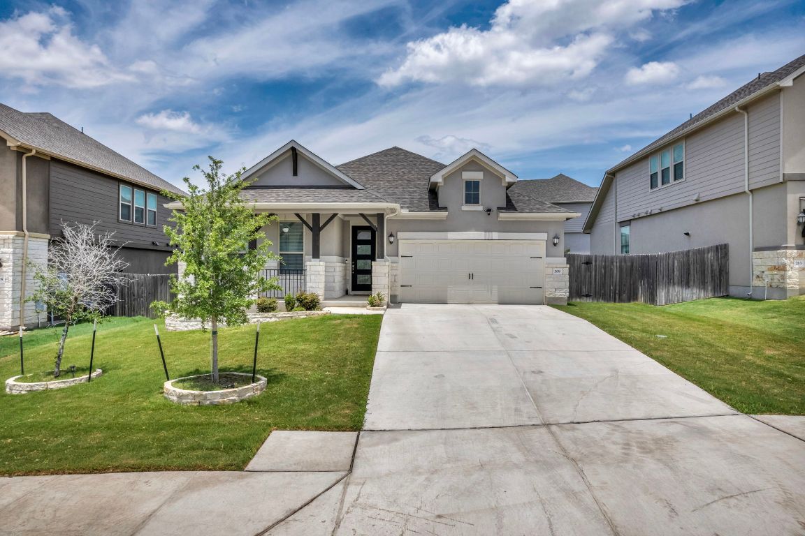 a front view of house with a garden