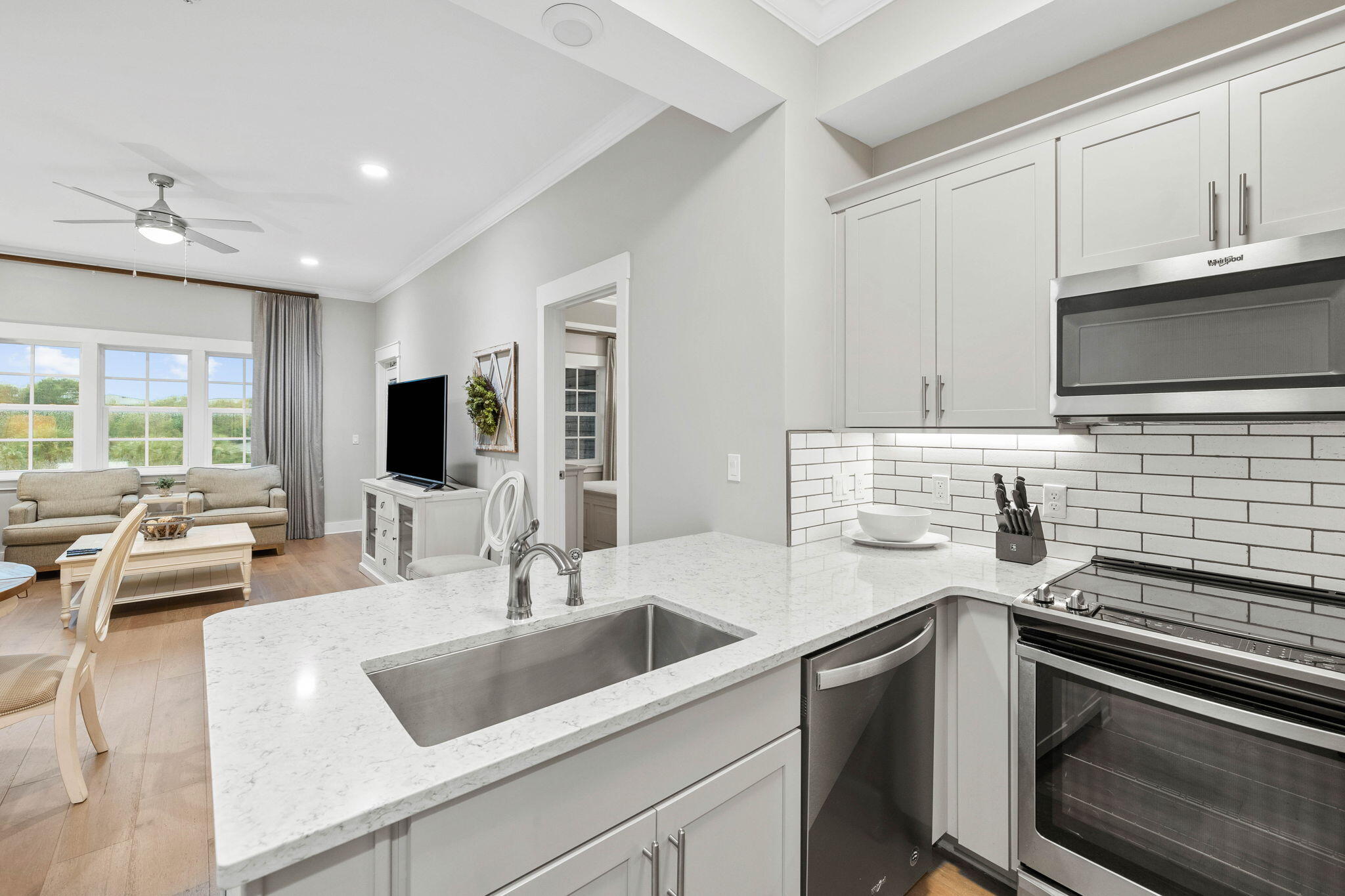 100 Matthew Boulevard, Unit 207 Destin, FL 32541 - Photo 12 of 29 a kitchen with a sink stove top oven and microwave