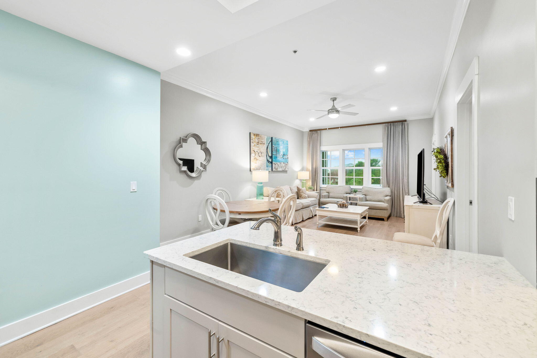 100 Matthew Boulevard, Unit 207 Destin, FL 32541 - Photo 14 of 29 a view of a kitchen counter top space a sink wooden floor and a window