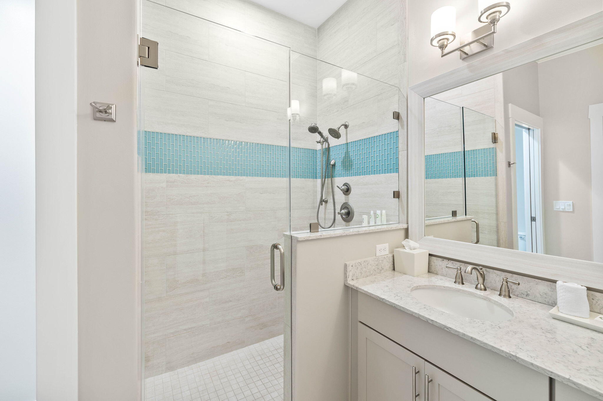 100 Matthew Boulevard, Unit 207 Destin, FL 32541 - Photo 24 of 29 a bathroom with a granite countertop sink a mirror and a shower