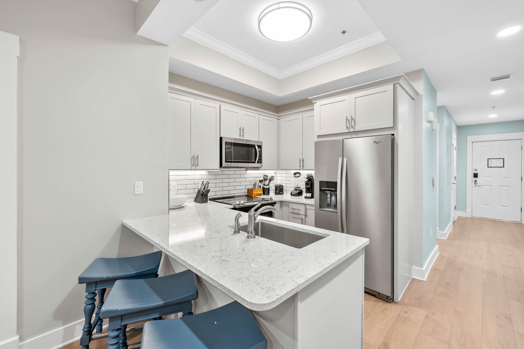 100 Matthew Boulevard, Unit 207 Destin, FL 32541 - Photo 9 of 29 a kitchen with a refrigerator a stove a sink and chairs