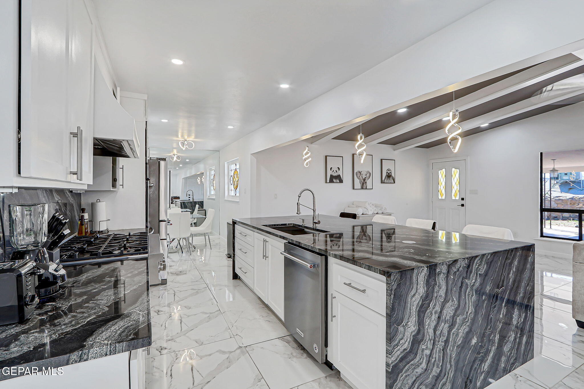 259 Crown Point Drive El Paso, TX 79912 - Photo 14 of 43 a kitchen with stainless steel appliances granite countertop a sink stove and cabinets