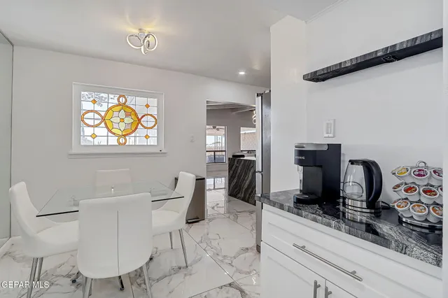 a kitchen with white cabinets and appliances