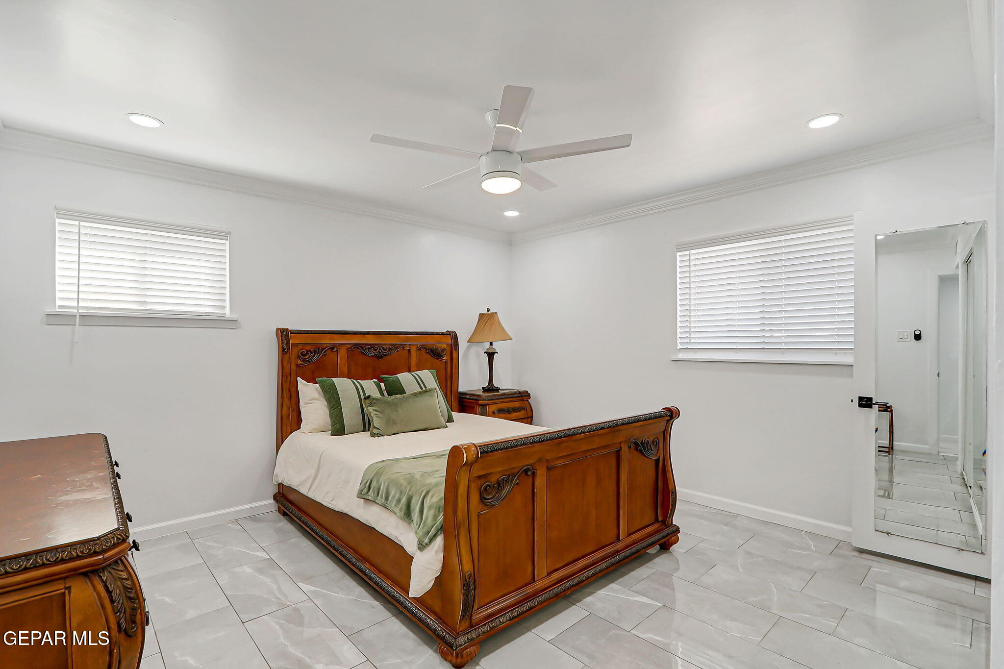 259 Crown Point Drive El Paso, TX 79912 - Photo 20 of 43 a bedroom with a bed and a mirror