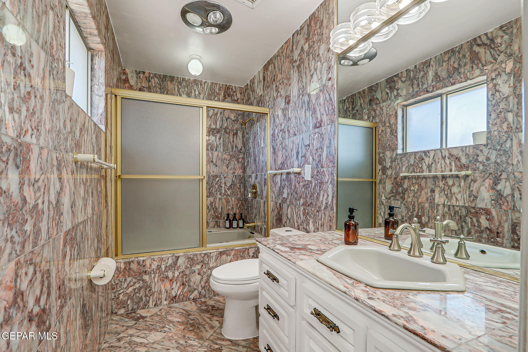 259 Crown Point Drive El Paso, TX 79912 - Photo 22 of 43 a bathroom with a granite countertop sink a toilet a mirror and shower