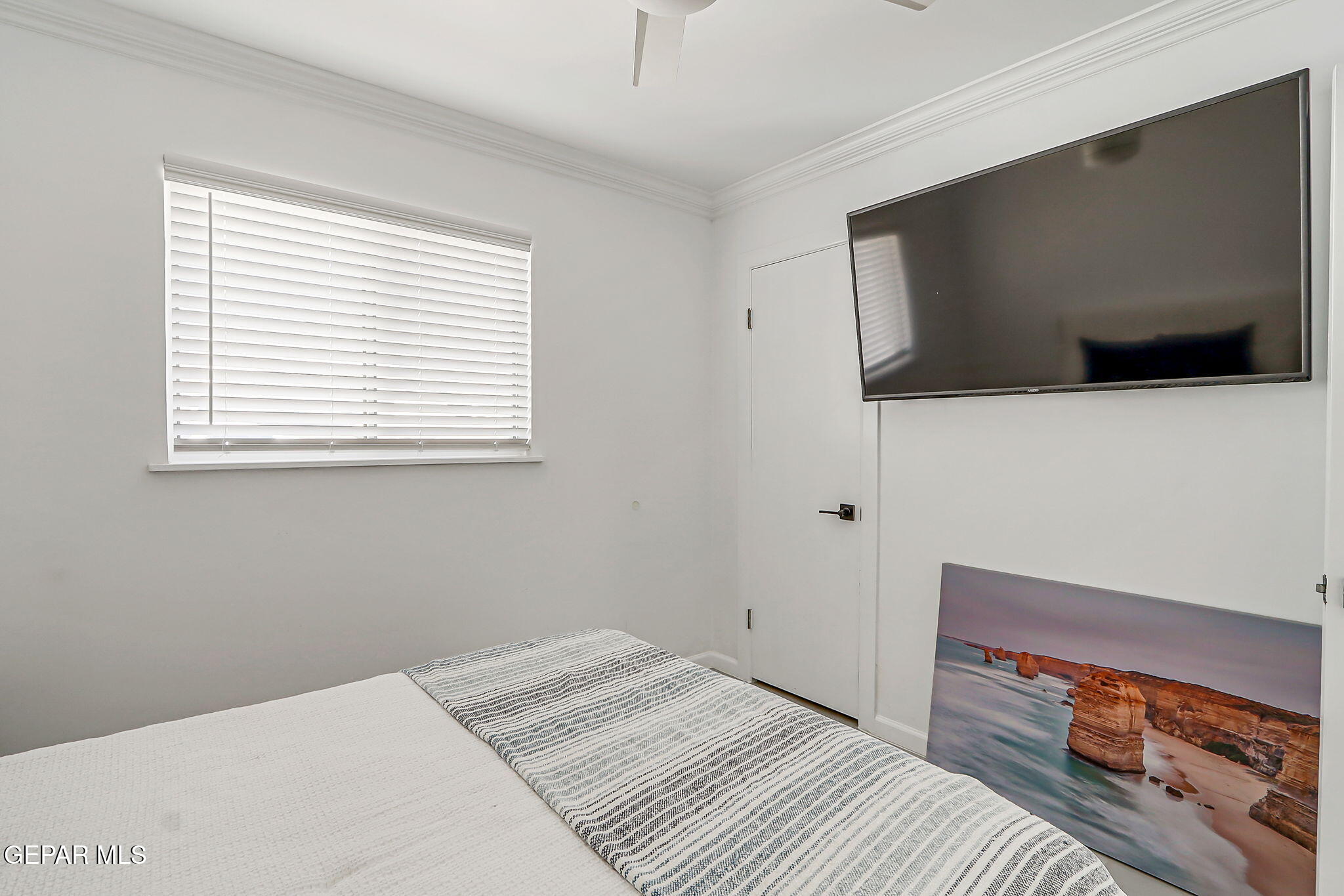 259 Crown Point Drive El Paso, TX 79912 - Photo 30 of 43 a bedroom with a bed and a flat screen tv