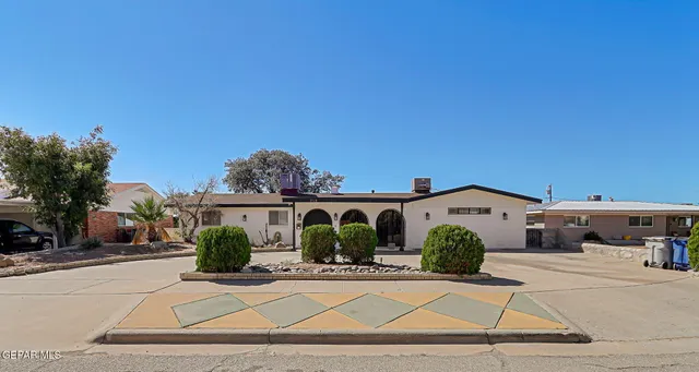 a view of house with outdoor space and tall trees