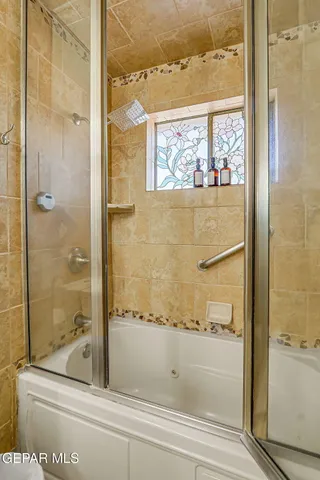 a bathroom with a bathtub and shower