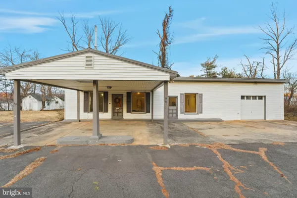 a front view of a house with a garden and entryway