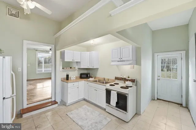 a kitchen with stainless steel appliances a stove a sink and a refrigerator