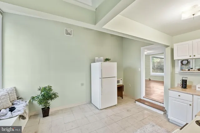a kitchen with a refrigerator and cabinets