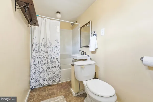 a white toilet sitting next to a bathroom sink
