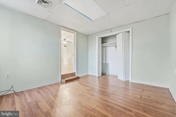 a view of an empty room with wooden floor