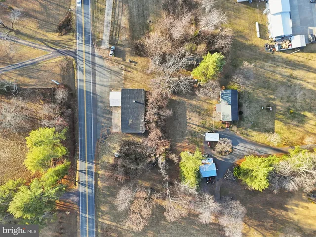 a view of swimming pool with a yard and large trees