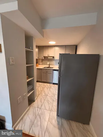 a bathroom with a sink vanity and toilet