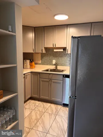 a white toilet sitting next to a bathroom sink