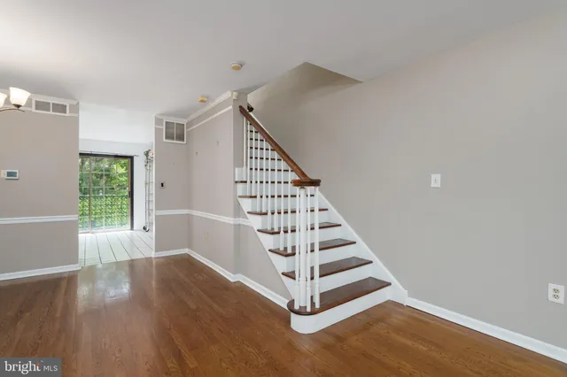 a view of entryway with wooden floor and stairs