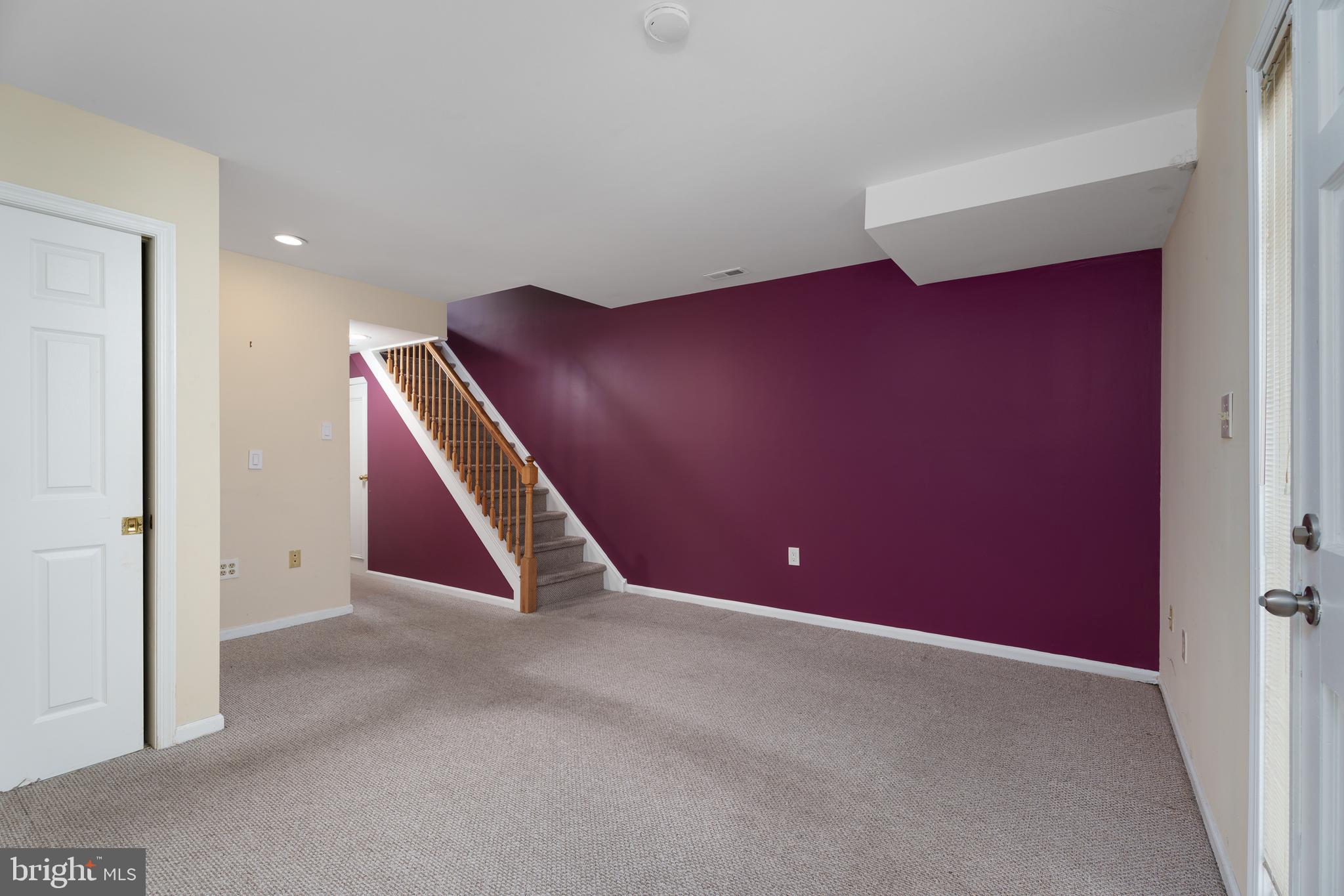 190 Mercer Street Trenton, NJ 08611 - Photo 21 of 34 an empty room with wooden floor and stairs