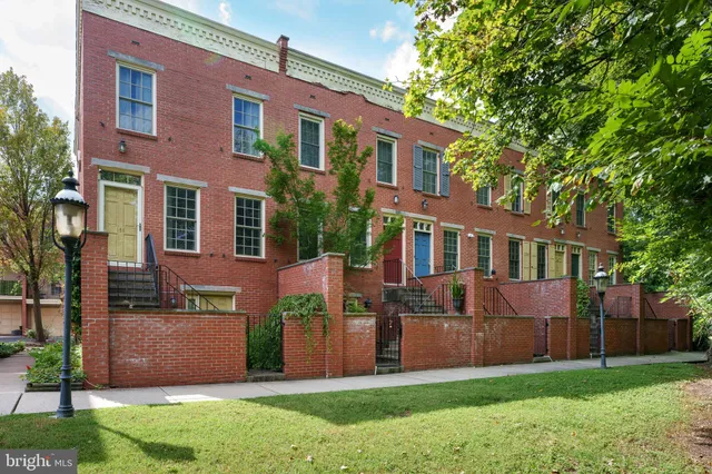 a view of a yard with wooden fence
