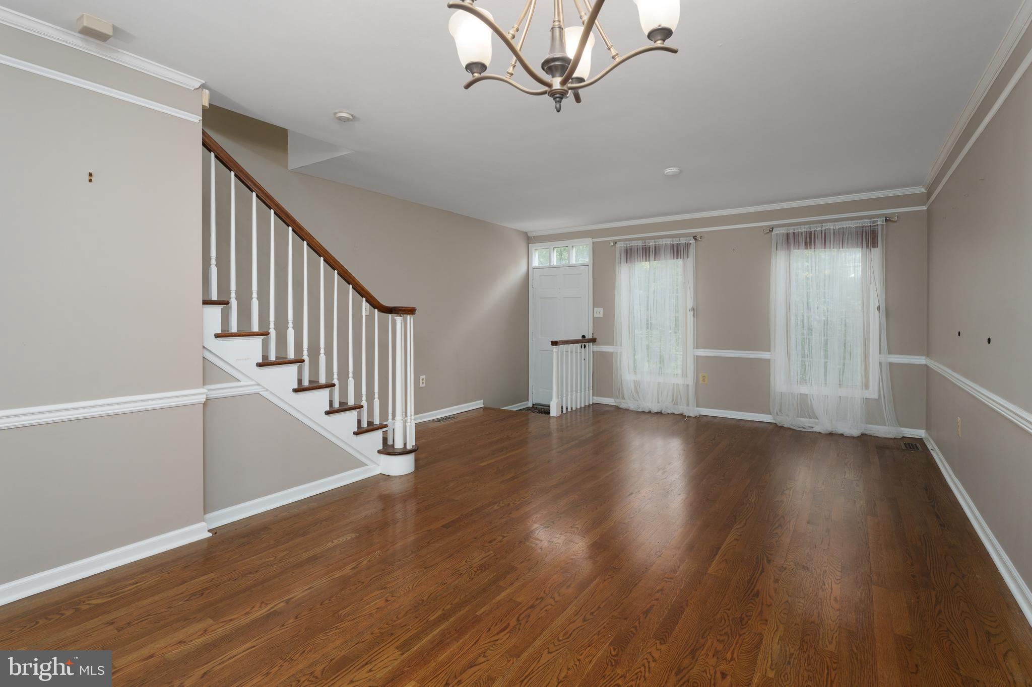 190 Mercer Street Trenton, NJ 08611 - Photo 5 of 34 a view of an empty room with wooden floor and stairs