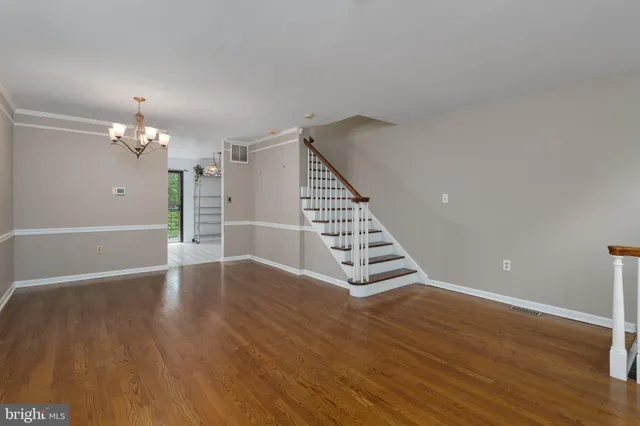 a view of wooden floor and windows in a room